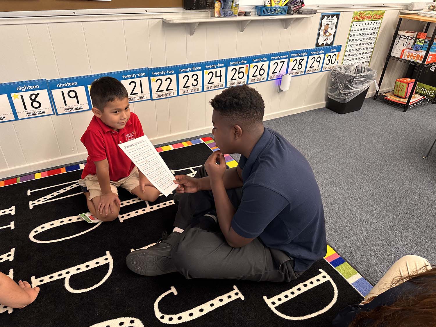 Older student helping younger student